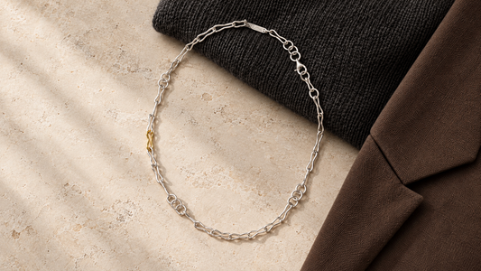 Golden Horn Bicolour Chain Necklace centred with charcoal knitwear and brown tailoring