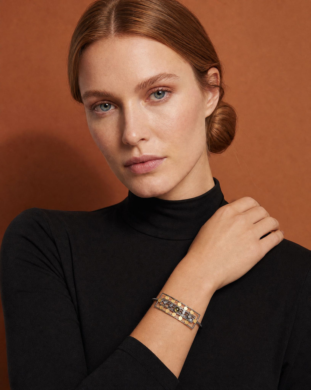 Model wearing the Ancient Queen Gemstone Bracelet with a black roll-neck – handmade jewellery by Golden Horn