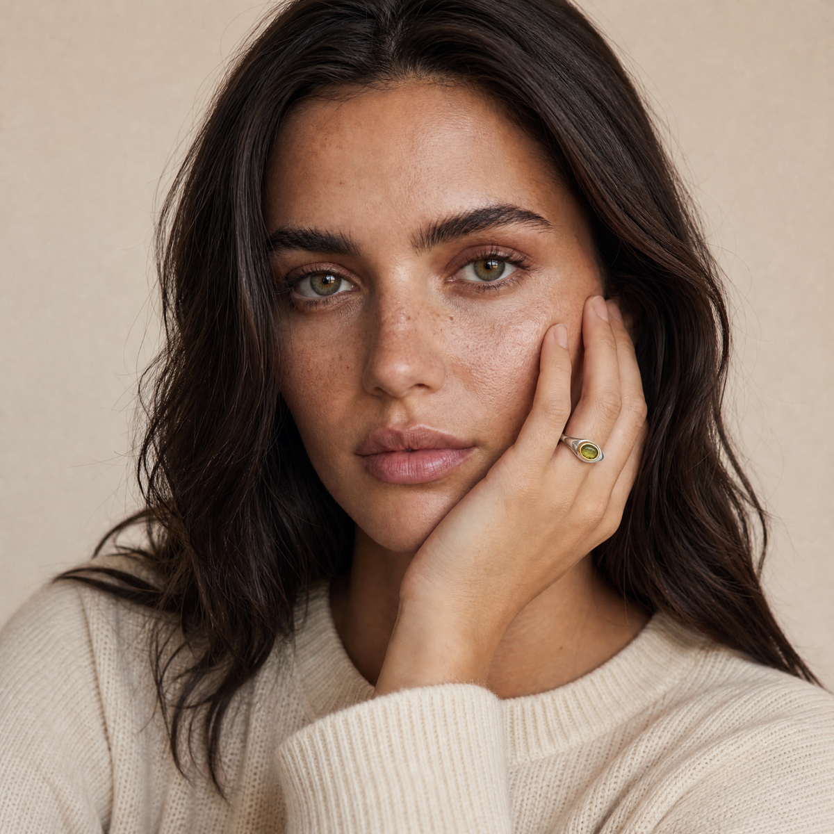 August Peridot Birthstone Ring worn on hand, model Erin in cream knit - Golden Horn Jewellery