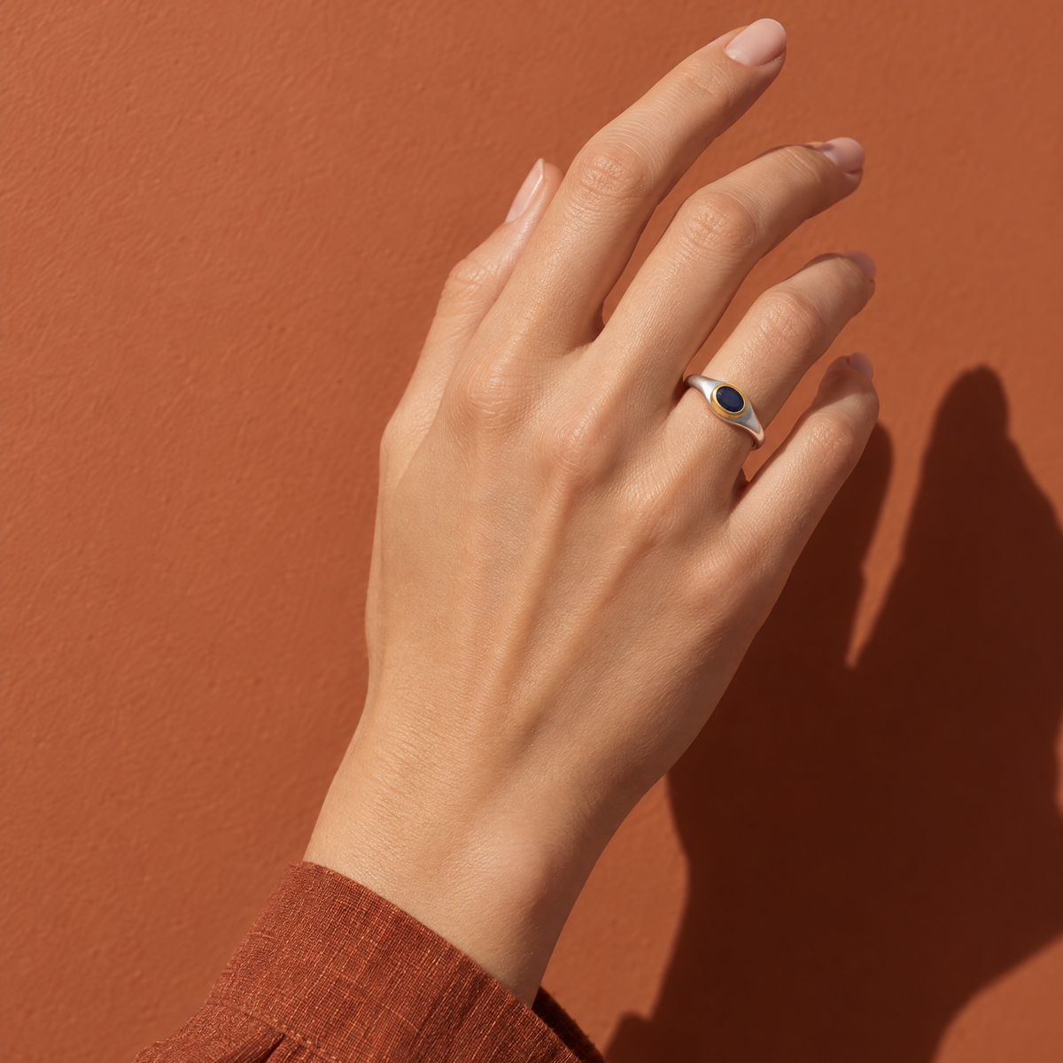 Hand wearing a sterling silver September sapphire birthstone ring — birthstone guide