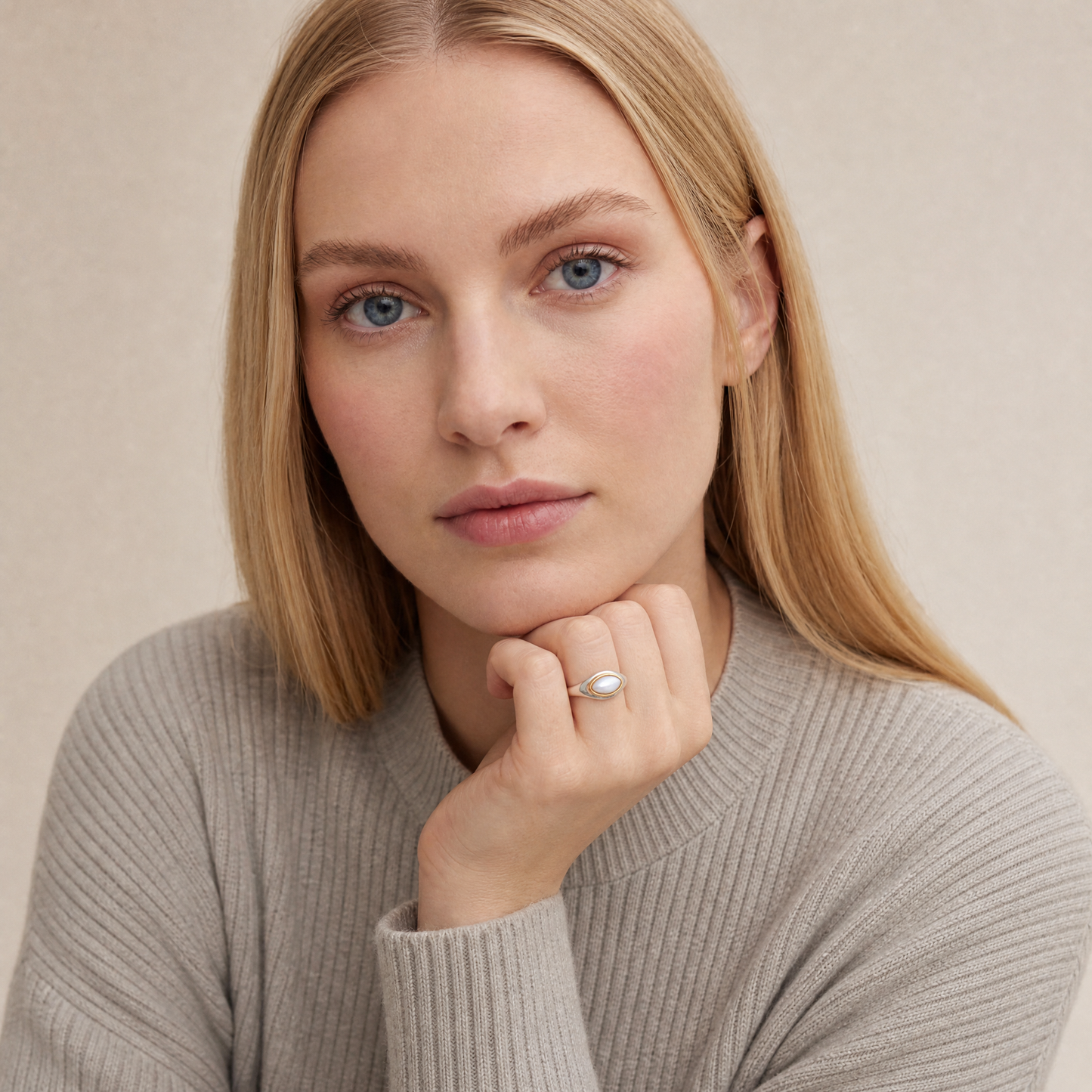 June Pearl Birthstone Ring worn on hand, model Lena in grey knit - Golden Horn Jewellery