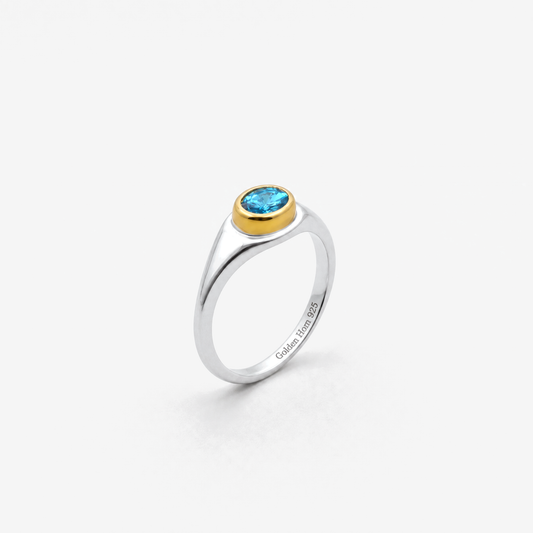 March Aquamarine Birthstone Ring in sterling silver with gold bezel, three-quarter view - Golden Horn Jewellery