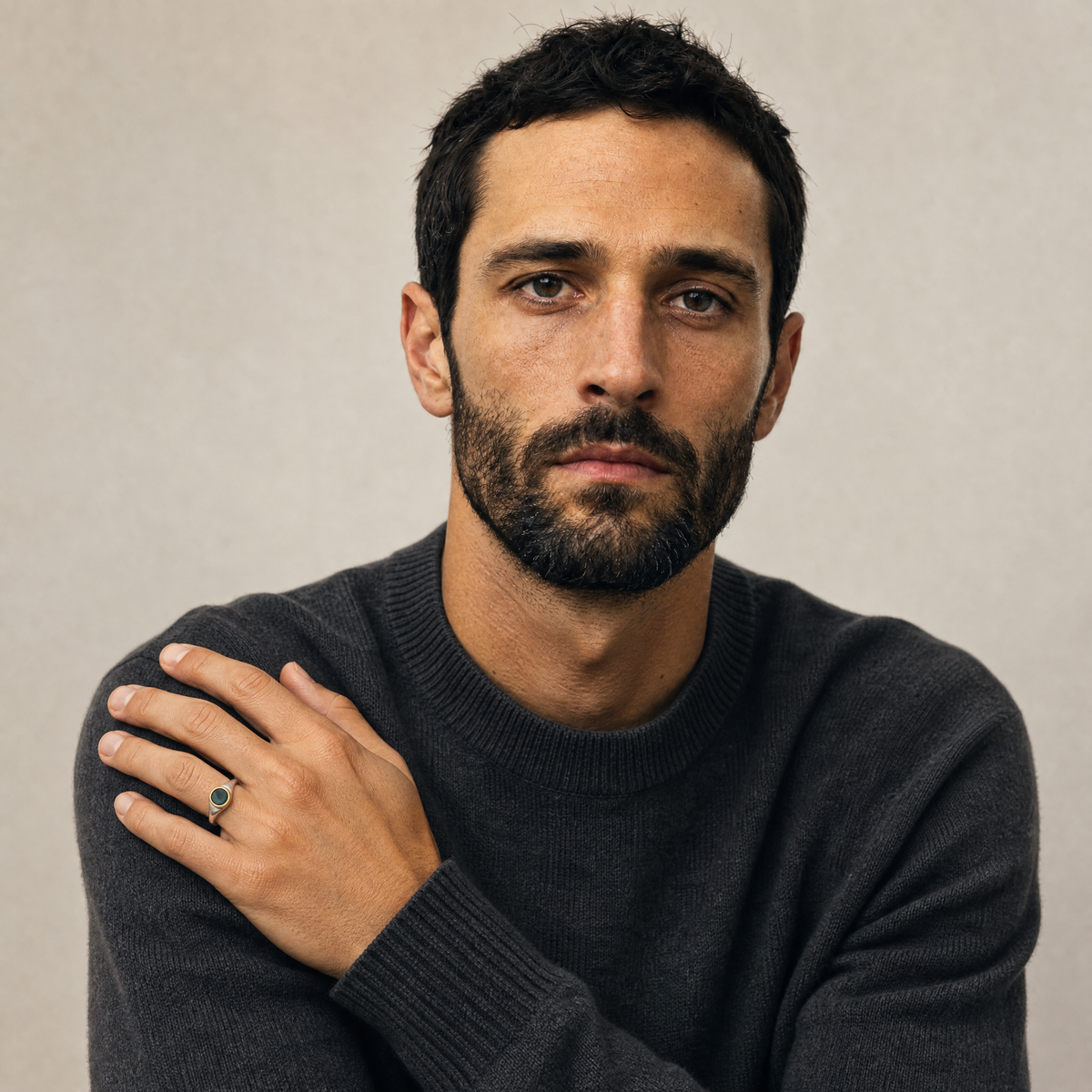 May Emerald Birthstone Ring worn on hand, model Marco in charcoal knit - Golden Horn Jewellery