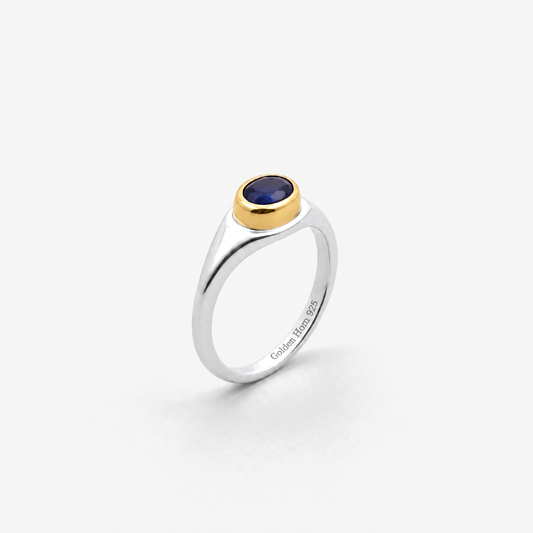 September Sapphire Birthstone Ring in sterling silver with gold bezel, three-quarter view - Golden Horn Jewellery