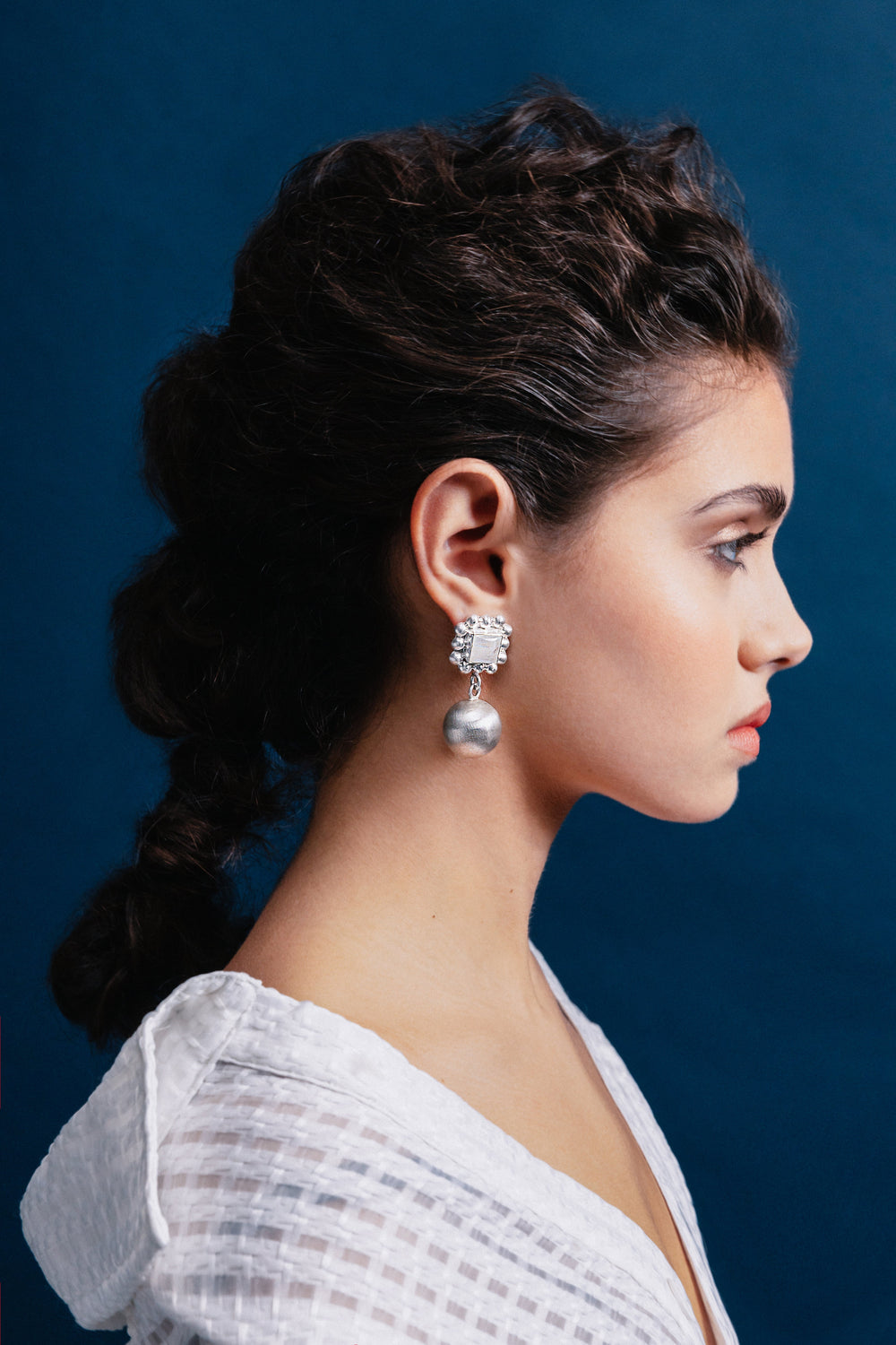 Model showcasing Golden Horn Jewellery’s handcrafted statement earrings, made from 925 sterling silver.