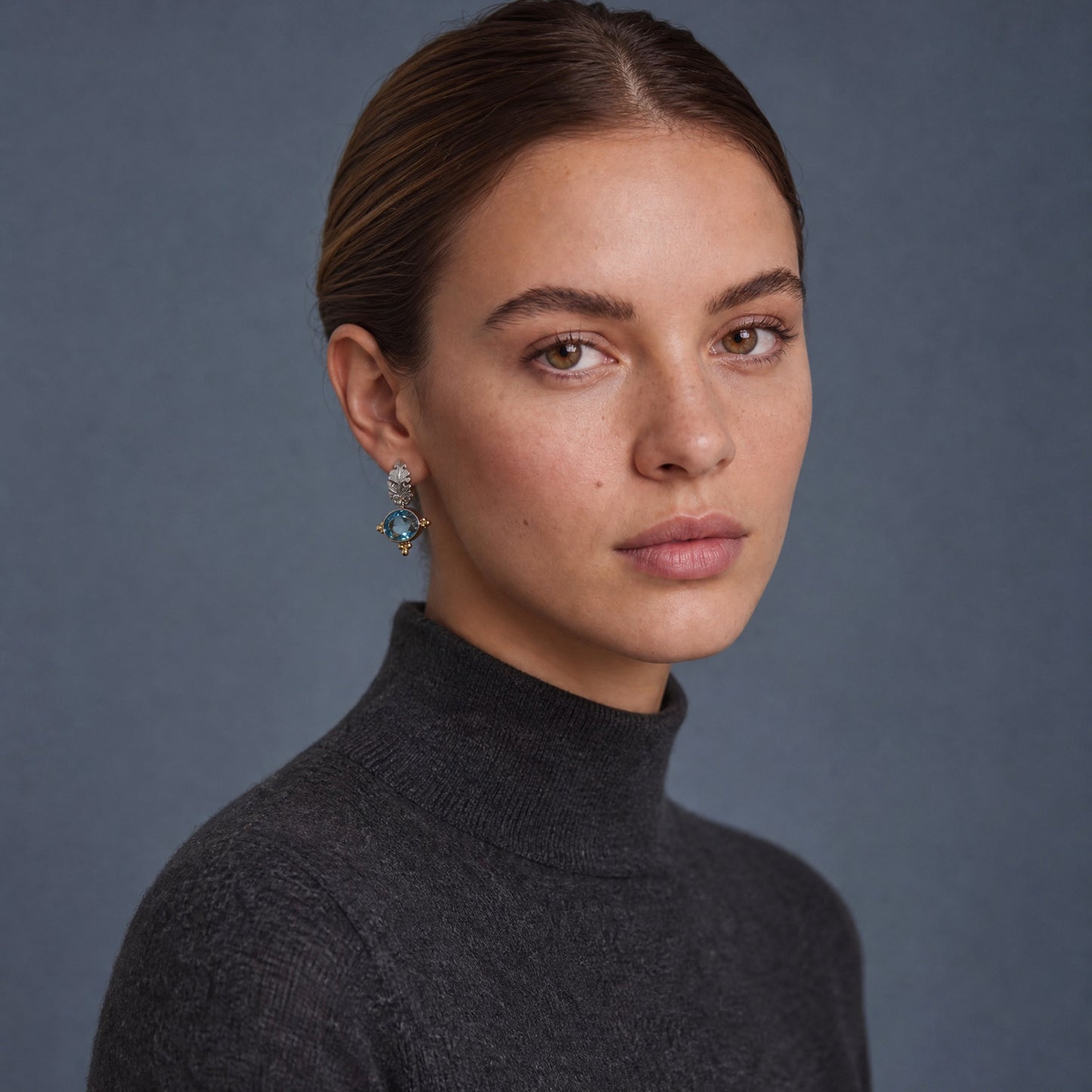 Athena's Wisdom Blue Topaz Gemstone Earrings worn on model – Golden Horn Jewellery