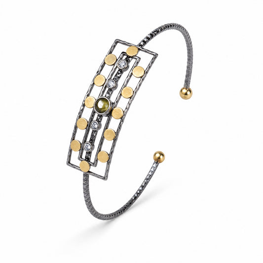 Ancient Queen Gemstone Bracelet at a three-quarter angle, oxidised silver cuff with gold discs and olive tourmaline – handmade jewellery by Golden Horn