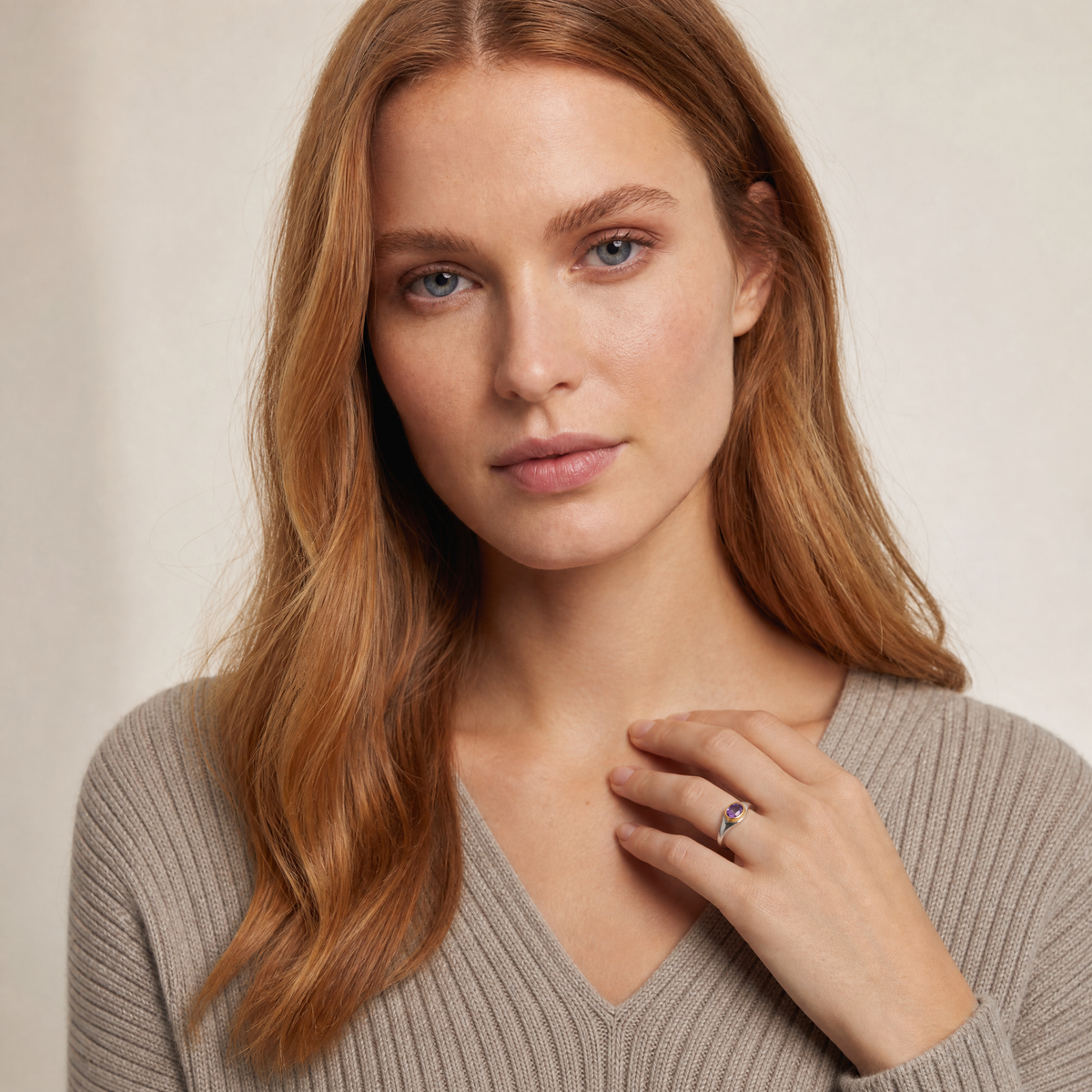February Amethyst Birthstone Ring worn on hand, model Serena in grey knit - Golden Horn Jewellery