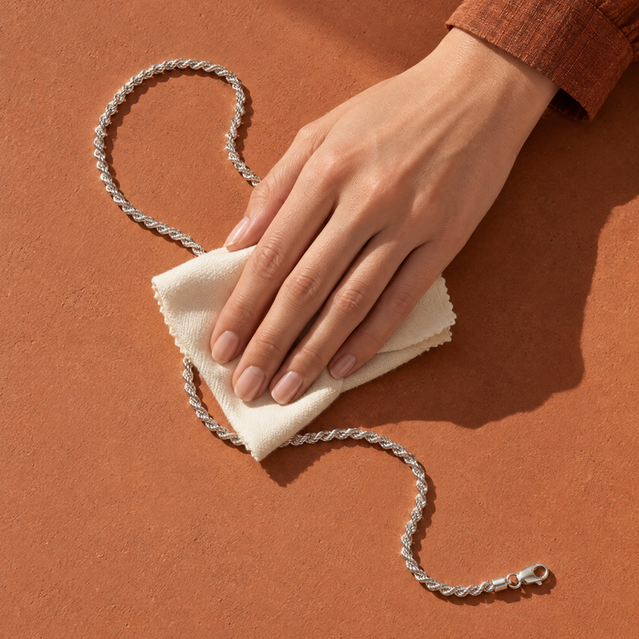 Polishing a sterling silver rope chain with a soft cloth — jewellery care