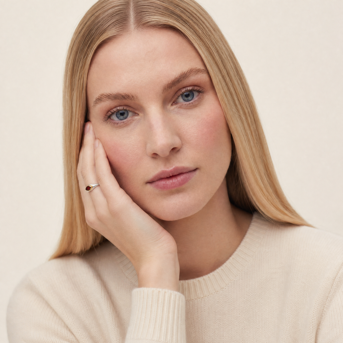 January Garnet Birthstone Ring worn on hand, model Lena in cream knit - Golden Horn Jewellery