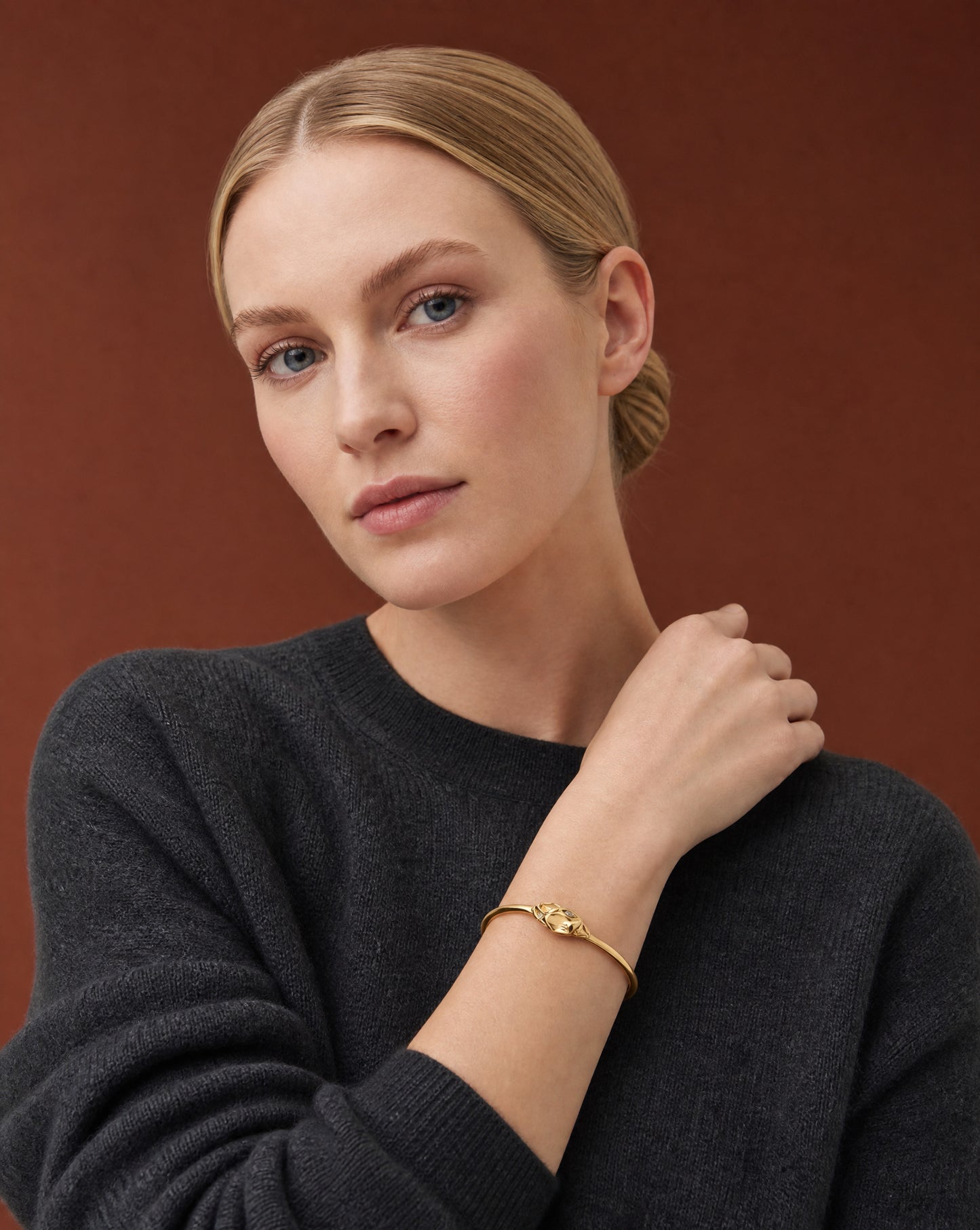 Model wearing the Ouroboros Snake Gold Plated Bracelet with a dark knit – handmade jewellery by Golden Horn
