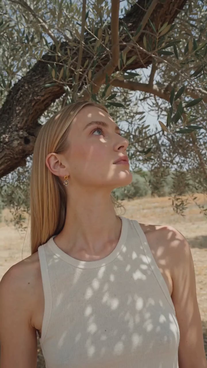 Spring Flower Circle Stud Earrings worn by a model under an olive tree