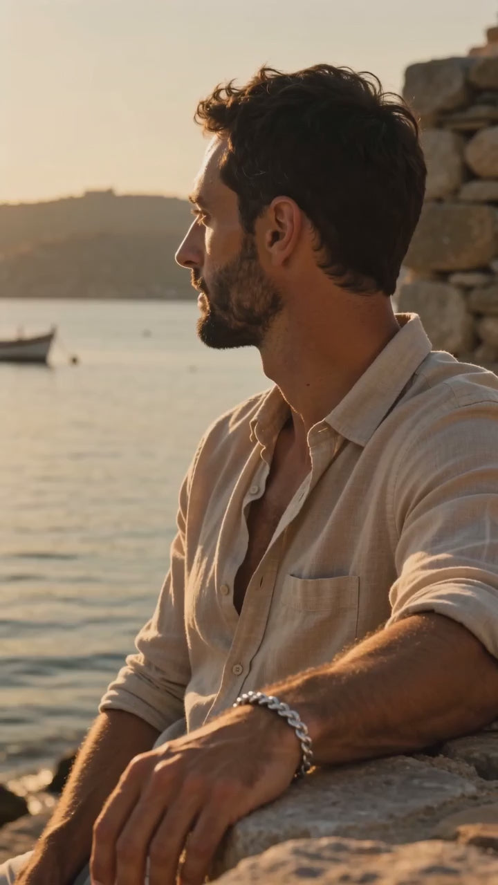 Silver Rope Chain Bracelet worn by a model at a harbour at golden hour
