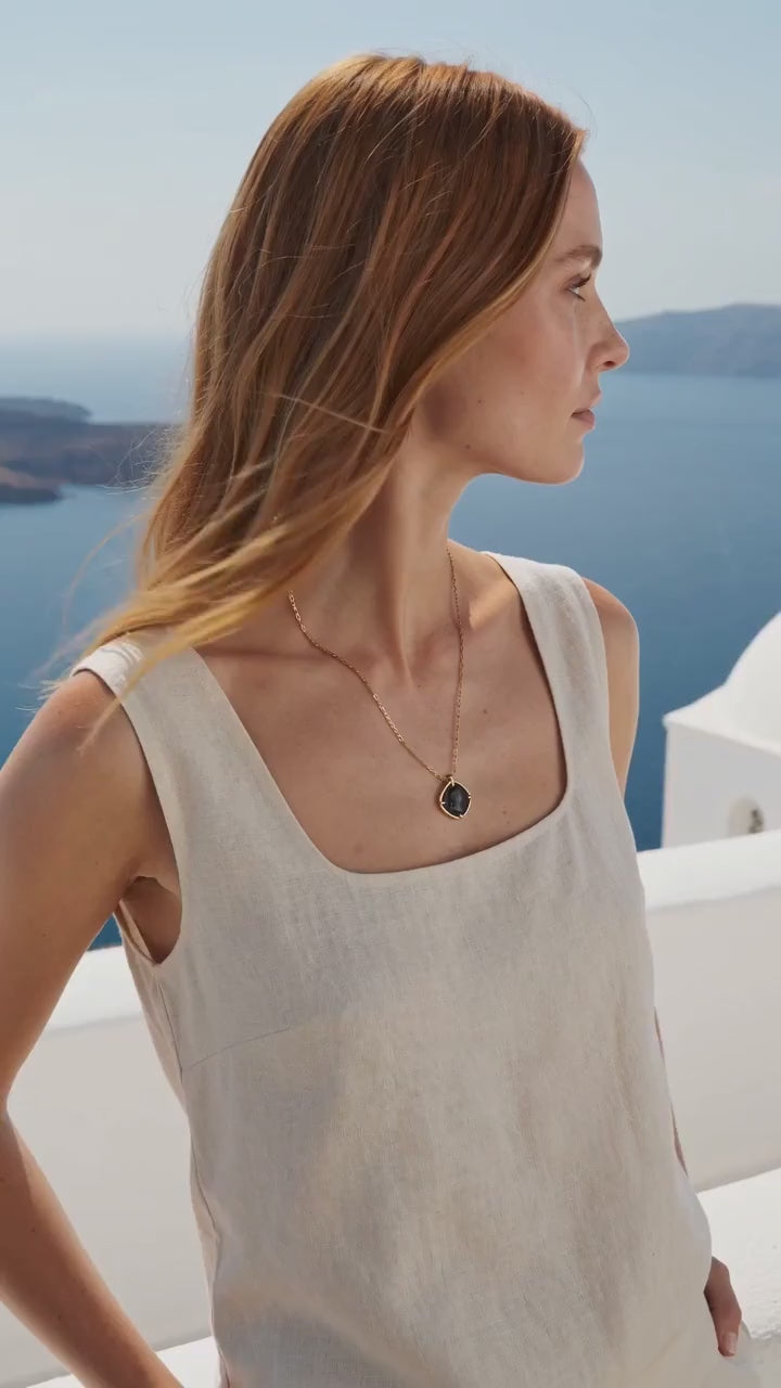 Apollo Black Agate Pendant Necklace worn by a model on an Aegean terrace